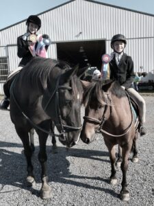 Image of girls with their horse and medals